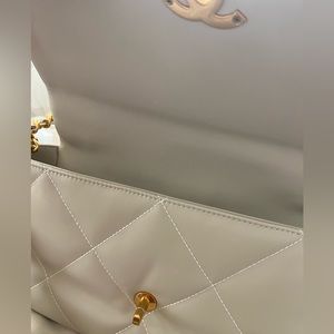 beige white quilted bag.